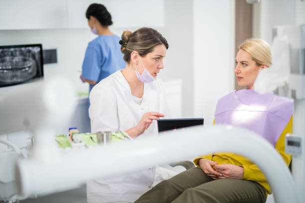 Dentist explaining treatment plan to patient while assessing Is Aspen Dental at Explaining Treatment Options clearly and transparently